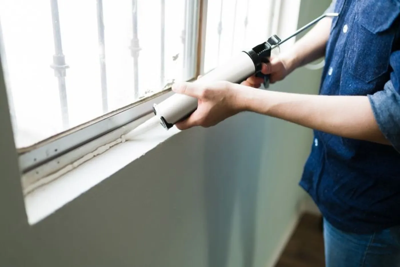 Handyman insulating his home windows
