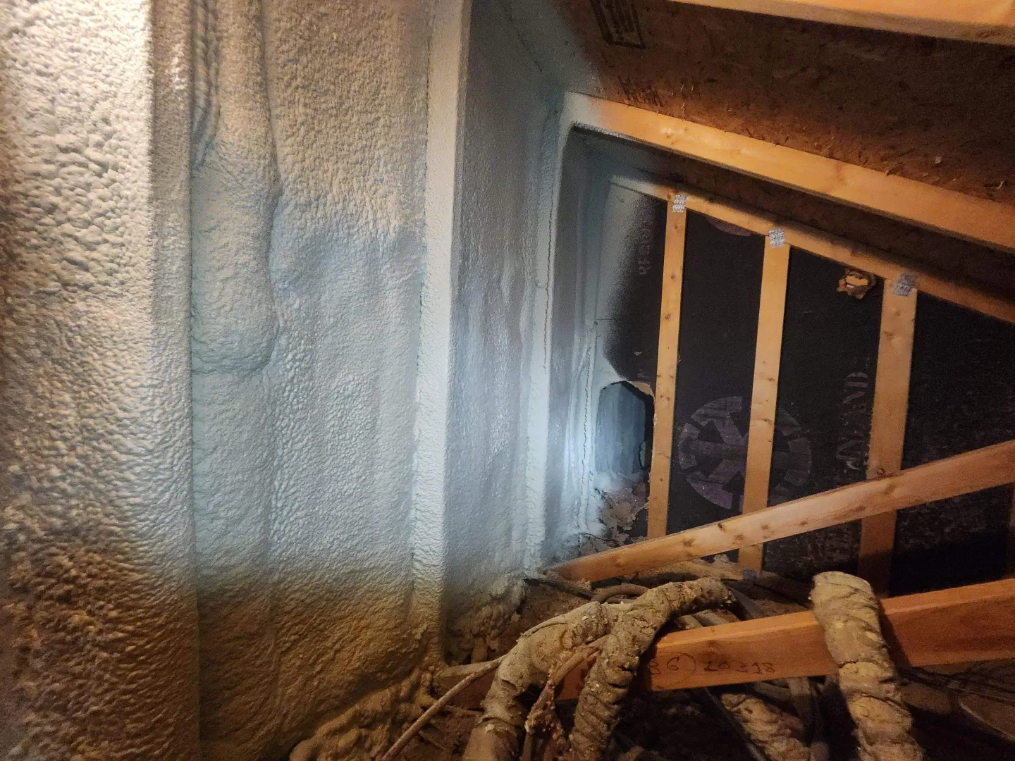 Closed-cell spray foam applied to an attic knee wall and rafter bay