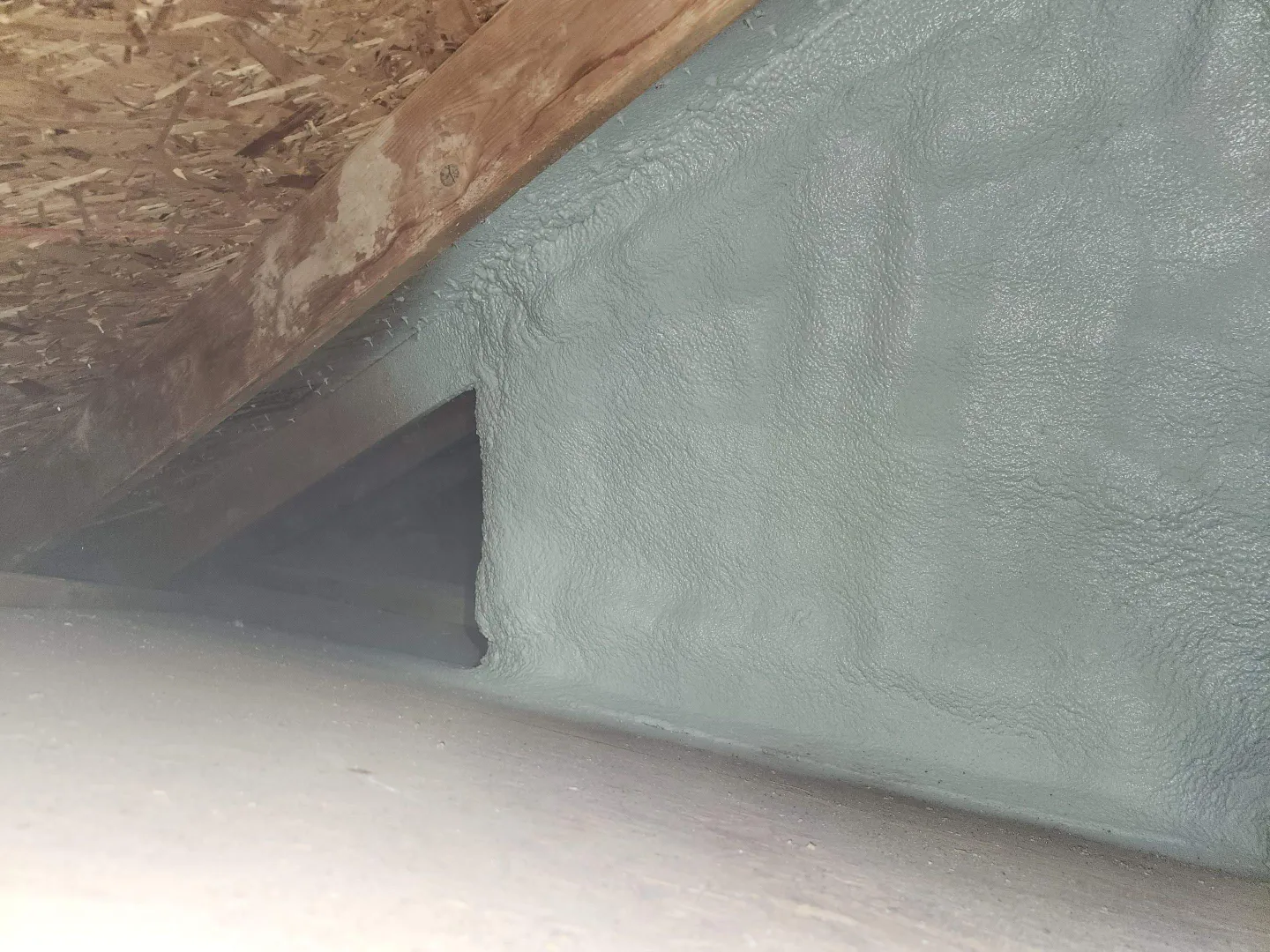 Attic knee wall fully spray foamed to seal and insulate the finished room behind it