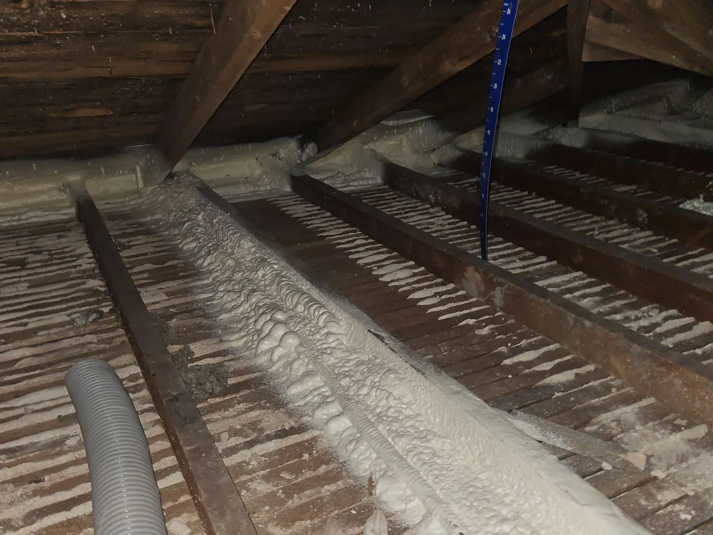 Spray foam sealed along every exterior top plate and joist in a Cheyenne attic, before the new insulation goes in